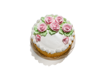 A cake with pink frosting and green leaves on top. The cake is decorated with pink roses. Dessert on transparent background PNG.