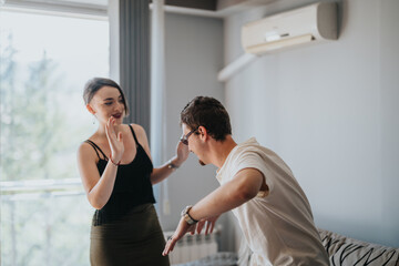Fototapeta premium A lighthearted moment between two friends enjoying a playful interaction in a contemporary living room setting, highlighting friendship and fun.