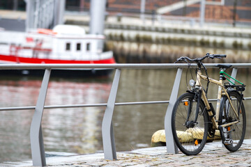 February winter day, outdoor bike transport by river stream, seasonal vehicle flow
