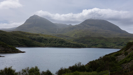 The beautiful nature in Scotland with the Lochs, mountains, rolling hills and cloudy skies and the green forests