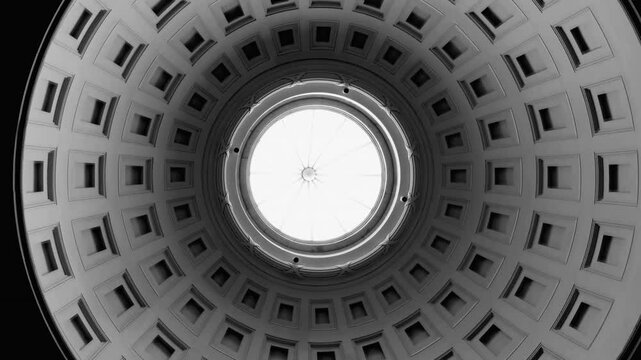 Looking up at a beautifully designed dome ceiling with geometric patterns and a skylight at the center, capturing the intricate architectural detail of the structure