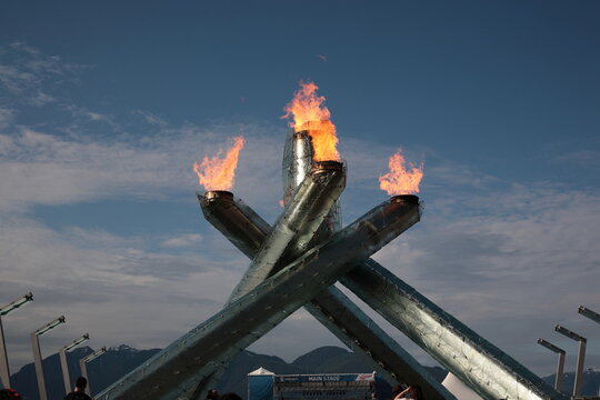 The 2010 Winter Olympic Cauldron burning celebrating 2011 Canada day at Vancouver coal harbour in downtown Vancouver, British Columbia, Canada.