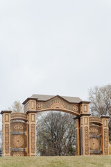 Naklejka premium Russian North Gates, large wooden gates with decorative ornament, art-object of Vyatka wooden architecture using wood carving, area fof tourists, located in Kirov, Russia
