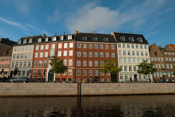 View across a canal to beautiful carved houses in Copenhagen. The capital of Denmark. Old colorful houses