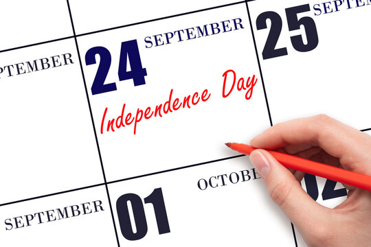 September 24. Hand writing text Independence Day on calendar date. Save the date.