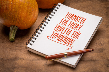 Thankful for today, hopeful for tomorrow - inspirational handwriting in a notebook with pumpkings, Thanskgiving concept