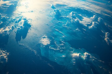 The vivid image of the ocean shows clouds casting shadows on its surface, combining elements of light and darkness in a captivating natural display.