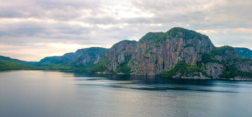 Vertical rocky cliffs on the shores of the Saguenay fjord, Quebec, Canada
