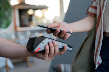 A person is using a credit card reader to pay for something