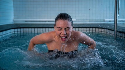 Woman in cold plunge tub, hydrotherapy for muscle recovery and wellness
