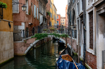 Scenic canal with ancient buildings and bridge in Venice, Italy.
