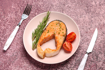 Plate of tasty salmon steak on purple background