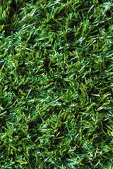 Obraz premium Detailed view of lush green artificial grass covering a large area in natural light during daytime