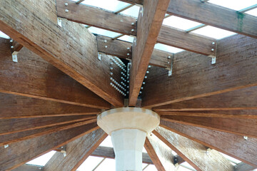 construction of a wooden canopy with a transparent roof made of massive beams, view from below