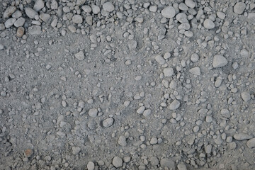 Dry mix for concrete mortar close-up, top view background, sand and gravel mixture with cement addition
