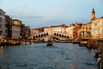 Panoramic view of famous Canal Grande with famous Rialto Bridge at sunset in Venice