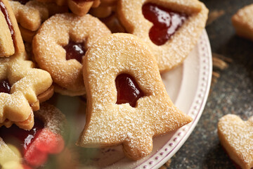 Traditonal Linzer Christmas cookies filled with strawberry marmalade and dusted with sugar, closeup