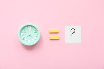 Alarm clock with question sign and blocks on pink background