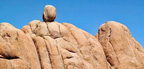 A granite boulder balanced atop a larger granite formation