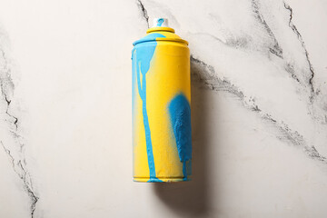 Spray paint can on marble background