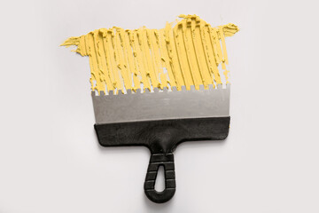 Knife with putty on light background