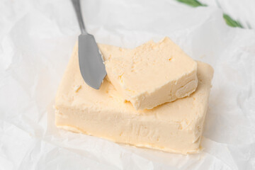 Baking paper with fresh butter and knife