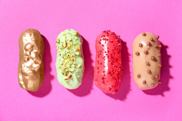 Delicious glazed eclairs on pink background