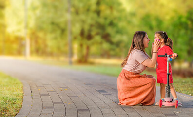 A young mother and daughter in the park.