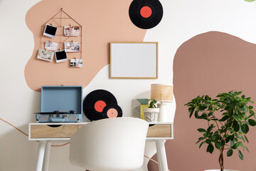 Interior of office with workplace, mood board and record player