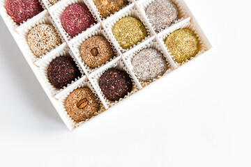 Box of healthy sweets, candies made from natural ingredients. Vegetarian organic food. White background, copy space