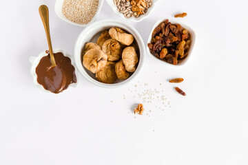 Energy dessert made from nuts, cacao, seeds, coconut, berry. Sugar free. Vegetarian organic food. White background, top view