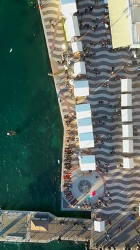 Aerial view of the Christmas markets in Lazise, Lake Garda, Italy. Vertical video, drone shot.