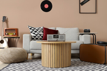 Interior of living room with sofa, table and radio receivers