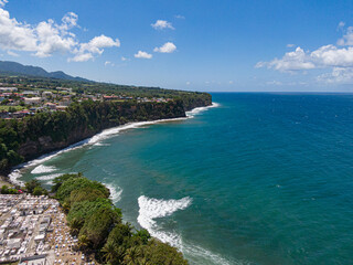 Waves breaking in front of Basse-pointe cemetary and in front of the ocean, Martinique, West Indies, France