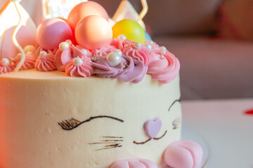 Kids birthday party. Colorful cake with candles, chocolate balls. Decorated table for child birthday celebration. Tasty Tower of Cream-Filled Cookies. round cake.food anniversary concept