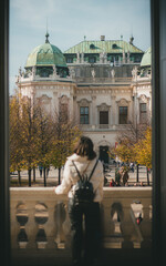 Woman admiring a historic Baroque palace in Vienna, Austria