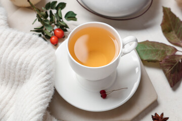 Composition with cup of green tea, sweater and autumn leaves on white background, closeup