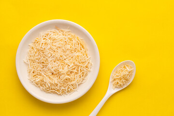 Cocos nucifera - Grated coconut with dehydrated sugar in the bowl and spoon.