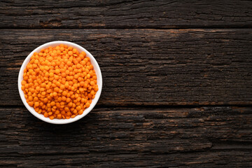 Lens culinaris - Bowl of raw red lentils.