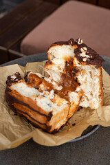 Deliciously baked chocolate caramel treat on a plate with parchment in a cozy café setting