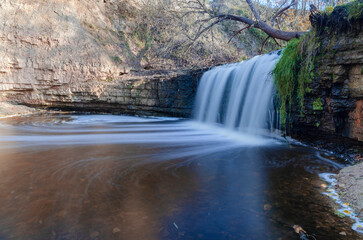 ablinsky Waterfall on a sunny October day at the Sablinsky Biolabirint hiking ecological route.