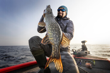Fisherman and trophy Pike. Fishing background.	