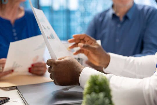 Middle aged couple engaged in a consultation with financial advisor about retirement planning, focusing on securing their financial future. Receiving professional advice for finances.