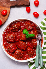Spicy beef meatballs with eggplant in tomato sauce.