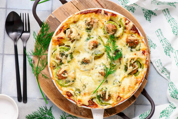 Baked zucchini rolls with minced meat, egg and cheese..selective focus