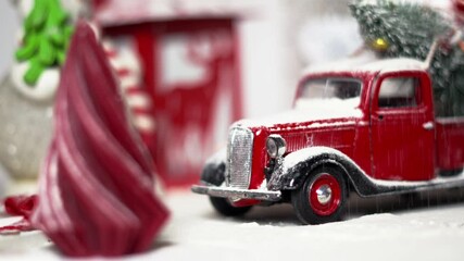 Vintage red truck covered in snow carries Christmas tree, creating nostalgic holiday vibes. Festive decorations and twinkling lights bring Christmas spirit, capturing magic of winter holiday season.