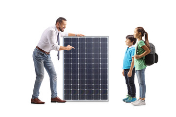 Man talking to children and pointing at a solar panel