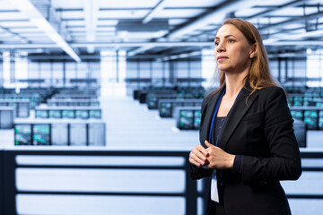 Employee in server hub using augmented reality to monitor energy consumption. Engineer in data center using AR visualization holograms to make sure rigs are functioning optimally