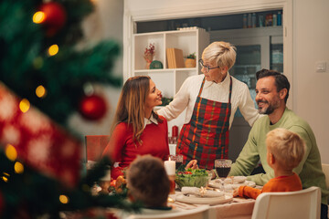 Happy family enjoying christmas dinner together at home