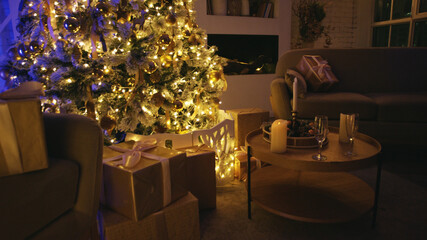 Beautifully decorated christmas tree is illuminating a cozy living room, with gift boxes and candles creating a warm and festive atmosphere